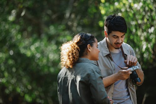 Focused diverse couple with photo camera