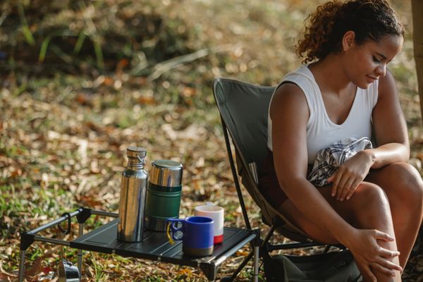 Portable camp chairs and table at an overlanding campsite