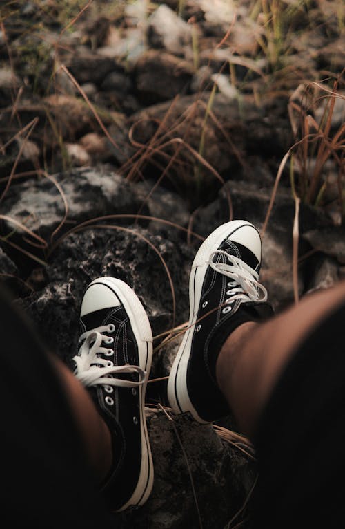 Person Wearing Black and White Converse Sneakers