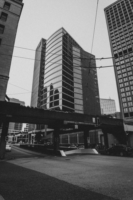 Black and white contemporary multistory glass buildings located in urban downtown in metropolis