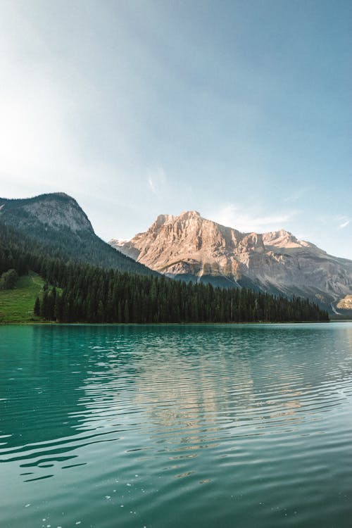 Peaceful water of rippling lake surrounded with mountains