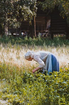 Side view of faceless female farmer in kerchief picking ripe plant in garden against wooden house with the Quote "It's easy to make a buck. It's a lot tougher to make a difference." written on it and have average color value #656345