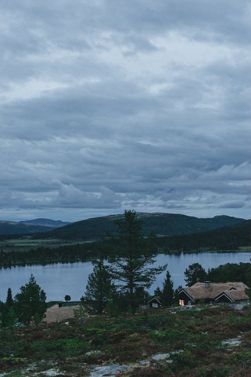 Calm lake and houses in mountainous valley