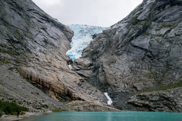 Rough Rocky Mountain Covered With Snow Near River