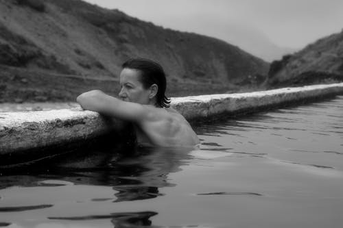 Grayscale Photo of Woman in Water