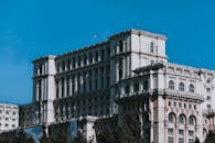 Neo classical palace with arched windows under bright blue sky