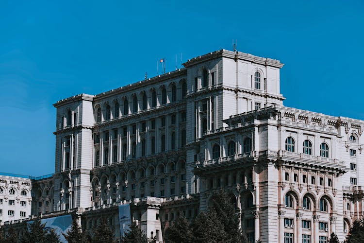 Neo Classical Palace With Arched Windows Under Bright Blue Sky