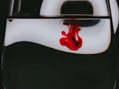 Red dye spilled into glass of water