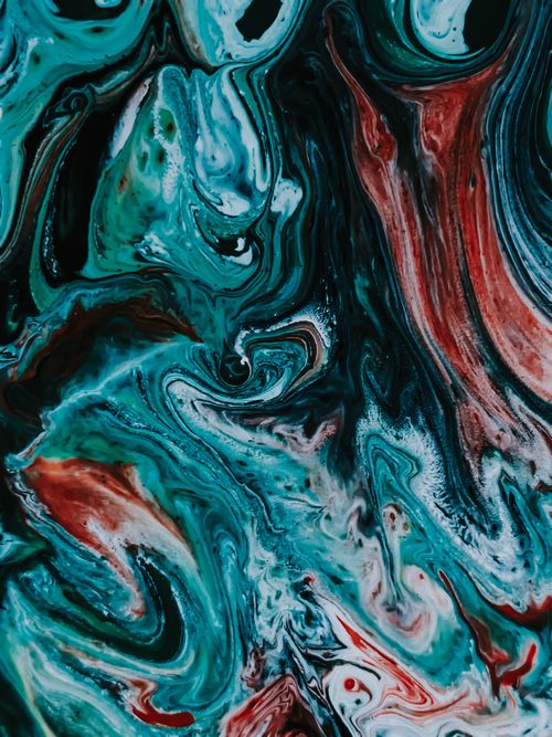 Free From above of multicolored acrylic paints mixing in modern creative technic fluid art Stock Photo