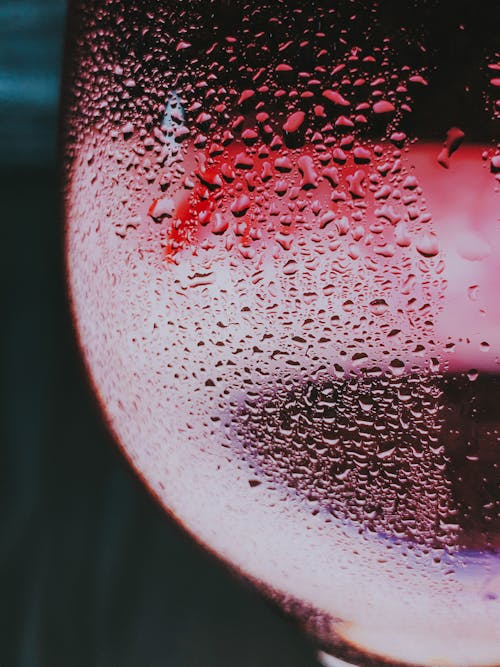 Glass of cold red wine with drops