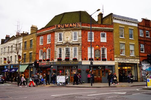 Free Bustling cityscape featuring the historic Golden Heart Pub, a classic London landmark. Stock Photo