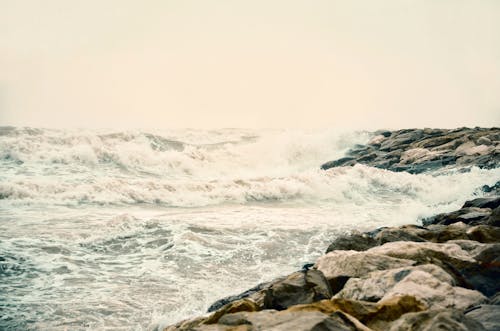 Free Photo of Ocean Waves Crashing on Big Rocks Stock Photo