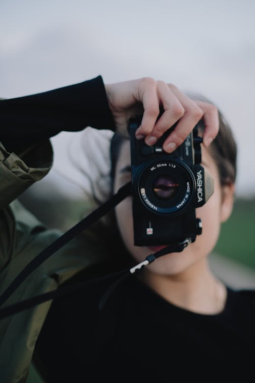 Woman taking photos on modern photo camera