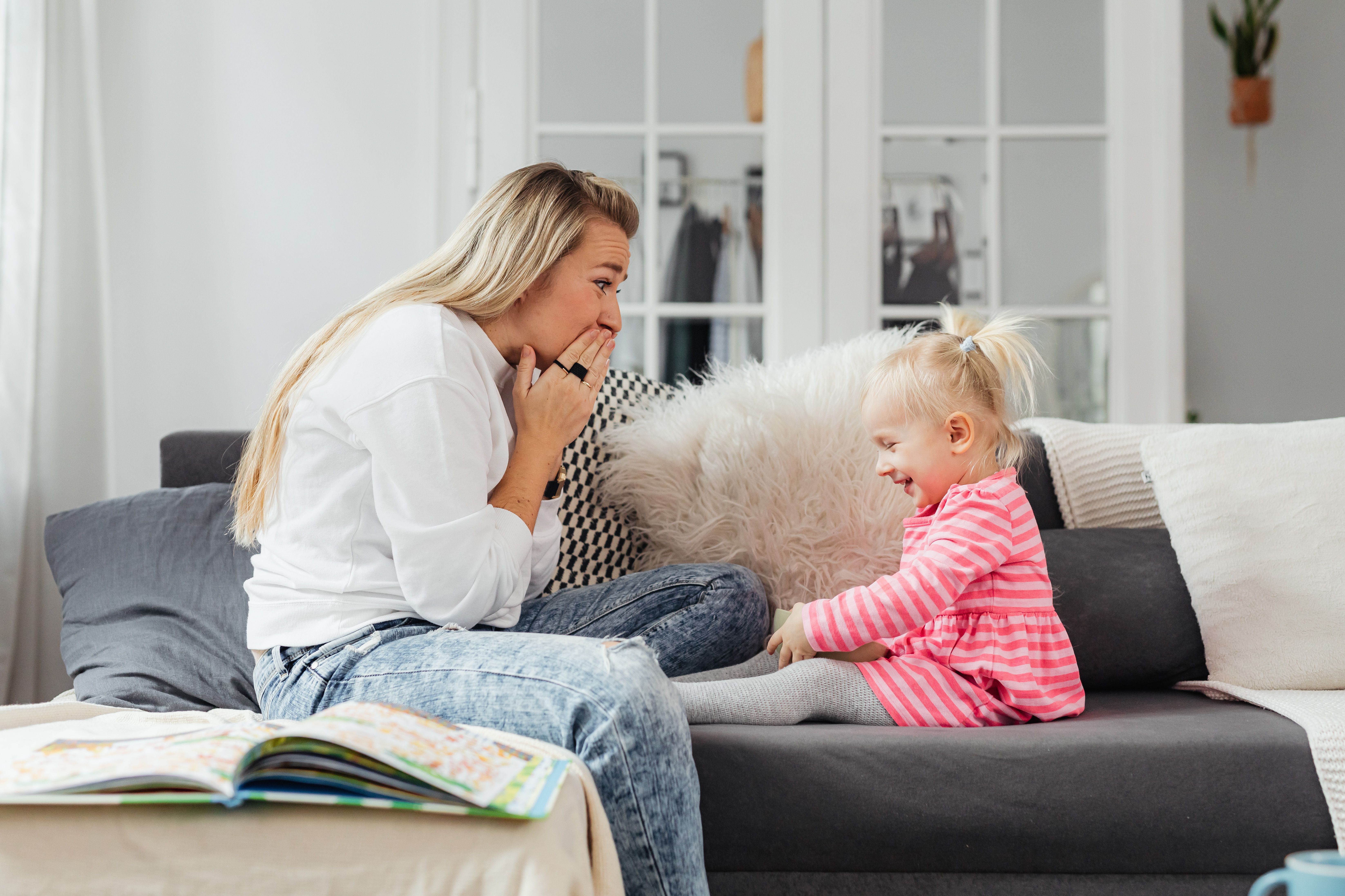 A loving moment between mother and daughter laughing together on a sofa in a cozy living room. - Photo by https://kaboompics.com/ on Pexels