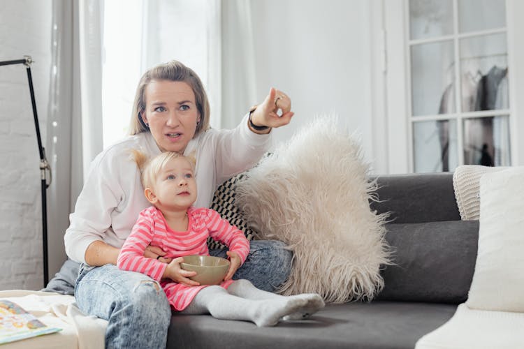 Woman Watching TV With Daughter