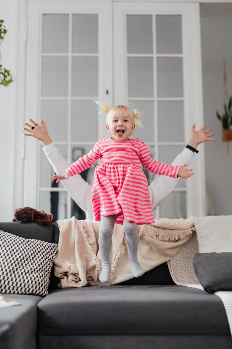 Girl Jumping On Couch