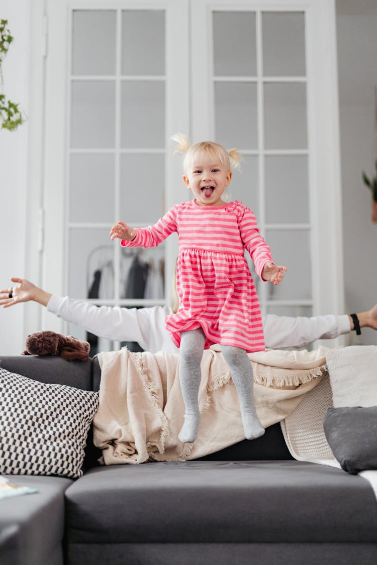 Little Girl Jumping On Couch