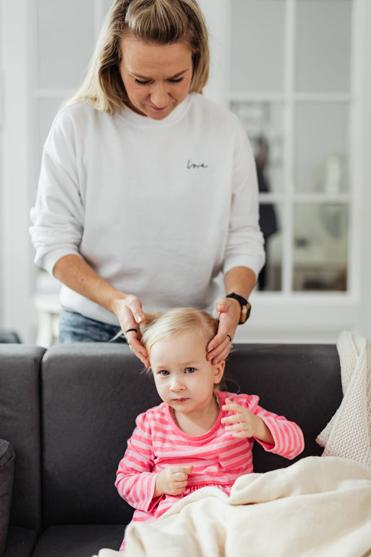 Woman Brushing Daughters Hair