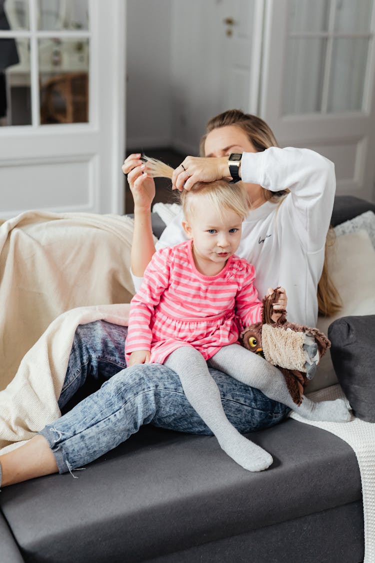 Mother Styling Daughters Hair