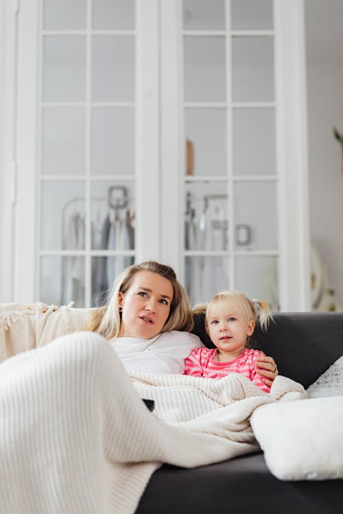 Free Mother and Daughter Lying On The Couch Stock Photo