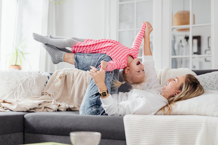 Blonde Girl Lying On The Woman's Shin 