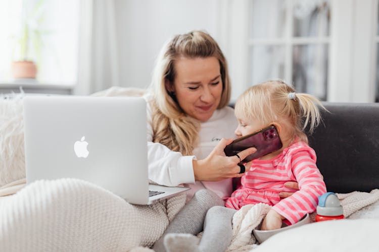 Mother And Daughter Talking On Smartphone