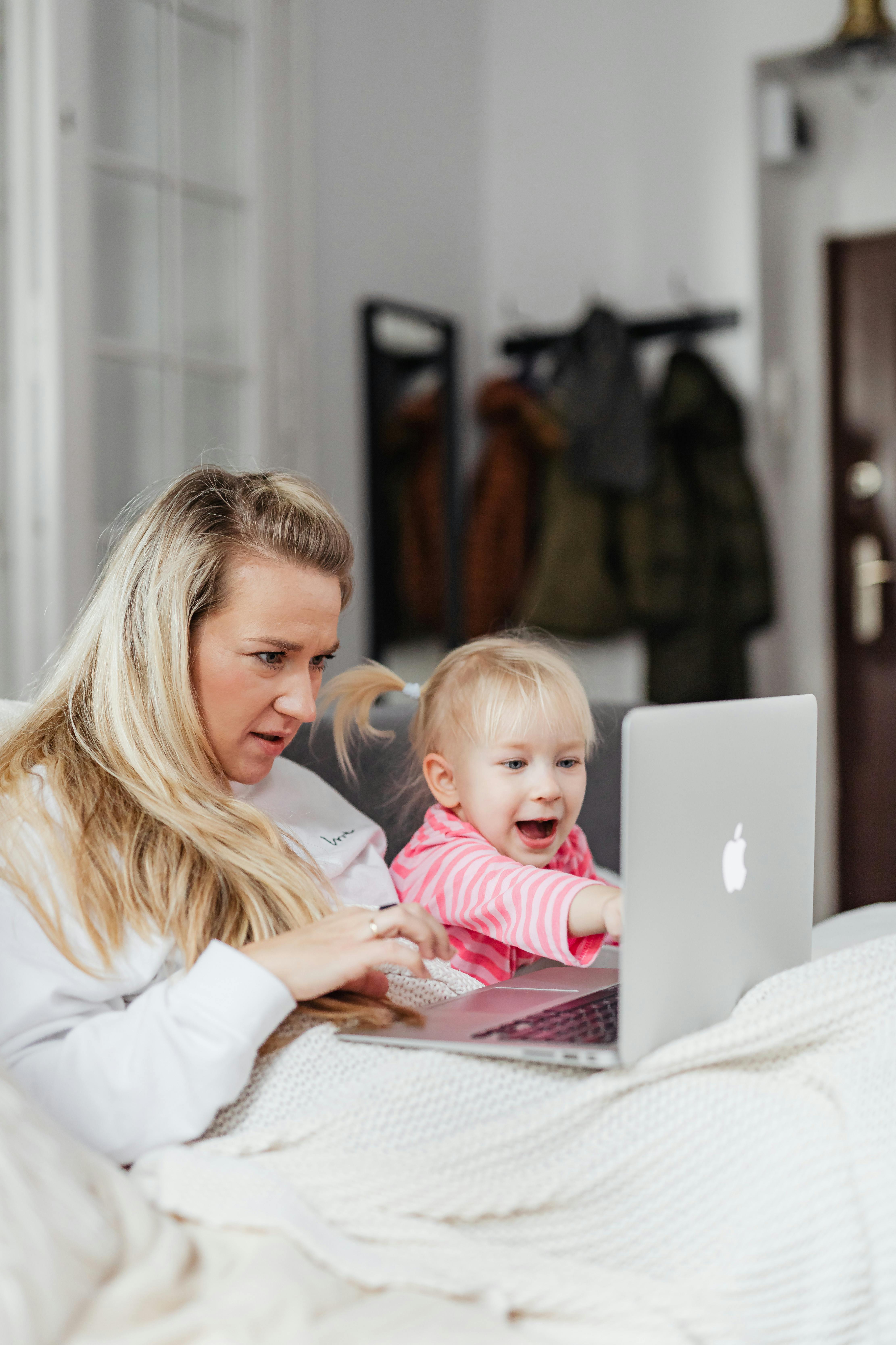 a mother and daughter watching on a laptop