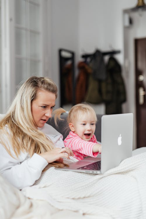 Free A Mother and Daughter Watching on a Laptop Stock Photo