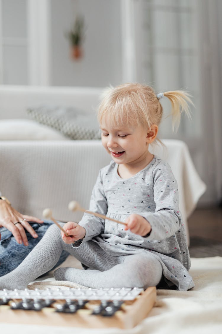 Little Girl Playing On Xylophone