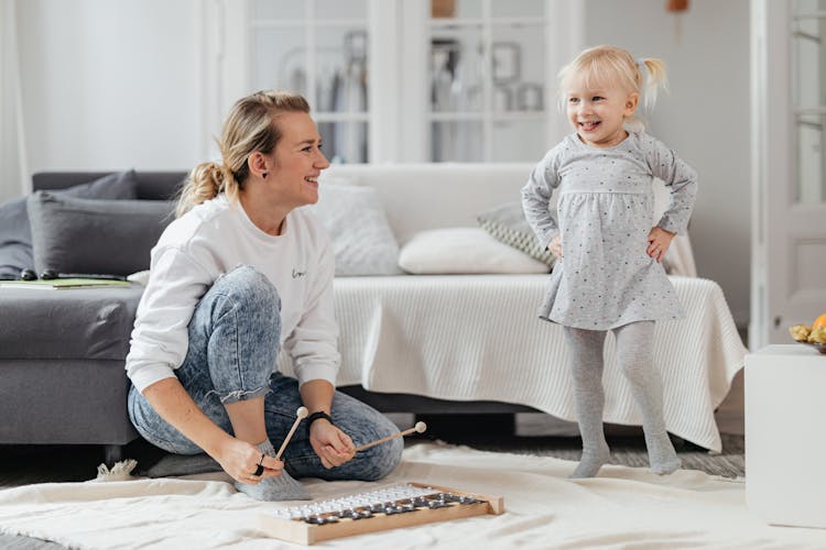 Mother And Daughter Playing With A Xylophone