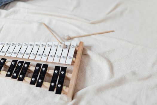 A Xylophone Lying Over a White Blanket
