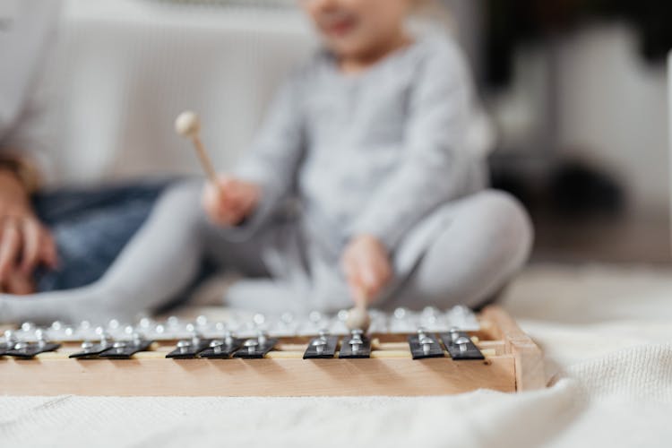 A Child Playing A Xylophone
