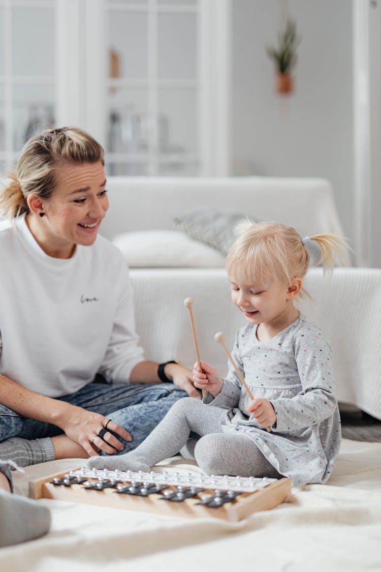 Little Girl Playing On Toy Xylophone