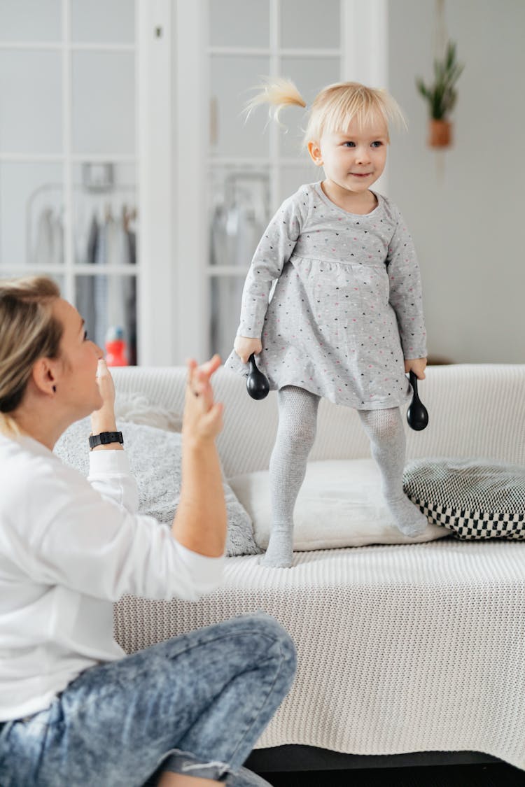 Pretty Little Girl Dancing On Sofa