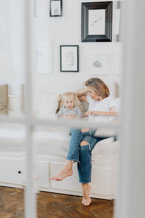 Free A Mother and Daughter Talking in the Bedroom Stock Photo