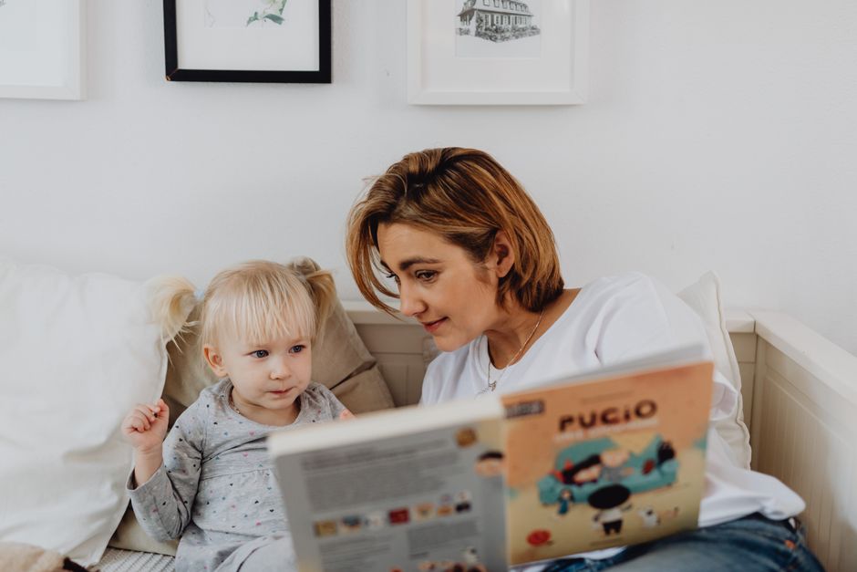 Photo by https://kaboompics.com/ on Pexels A mother and her daughter sharing a bonding moment while reading a children's book in the bedroom. - Photo by https://kaboompics.com/ on Pexels