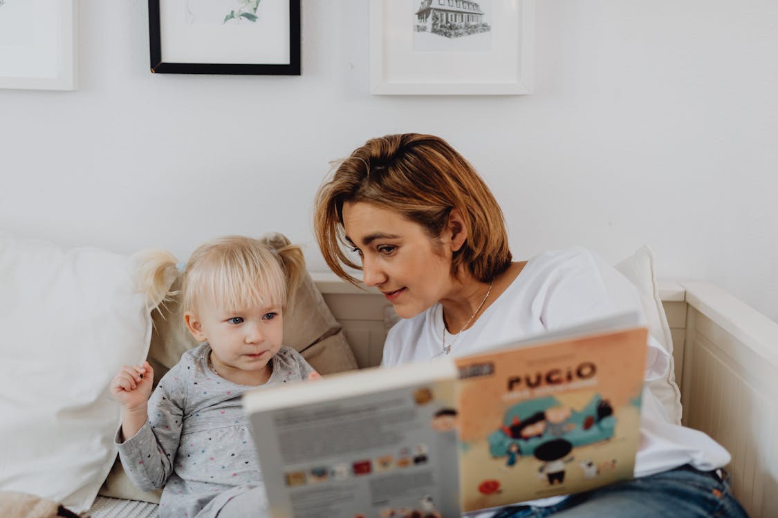 Free A Mom Reading a Book for Her Child Stock Photo