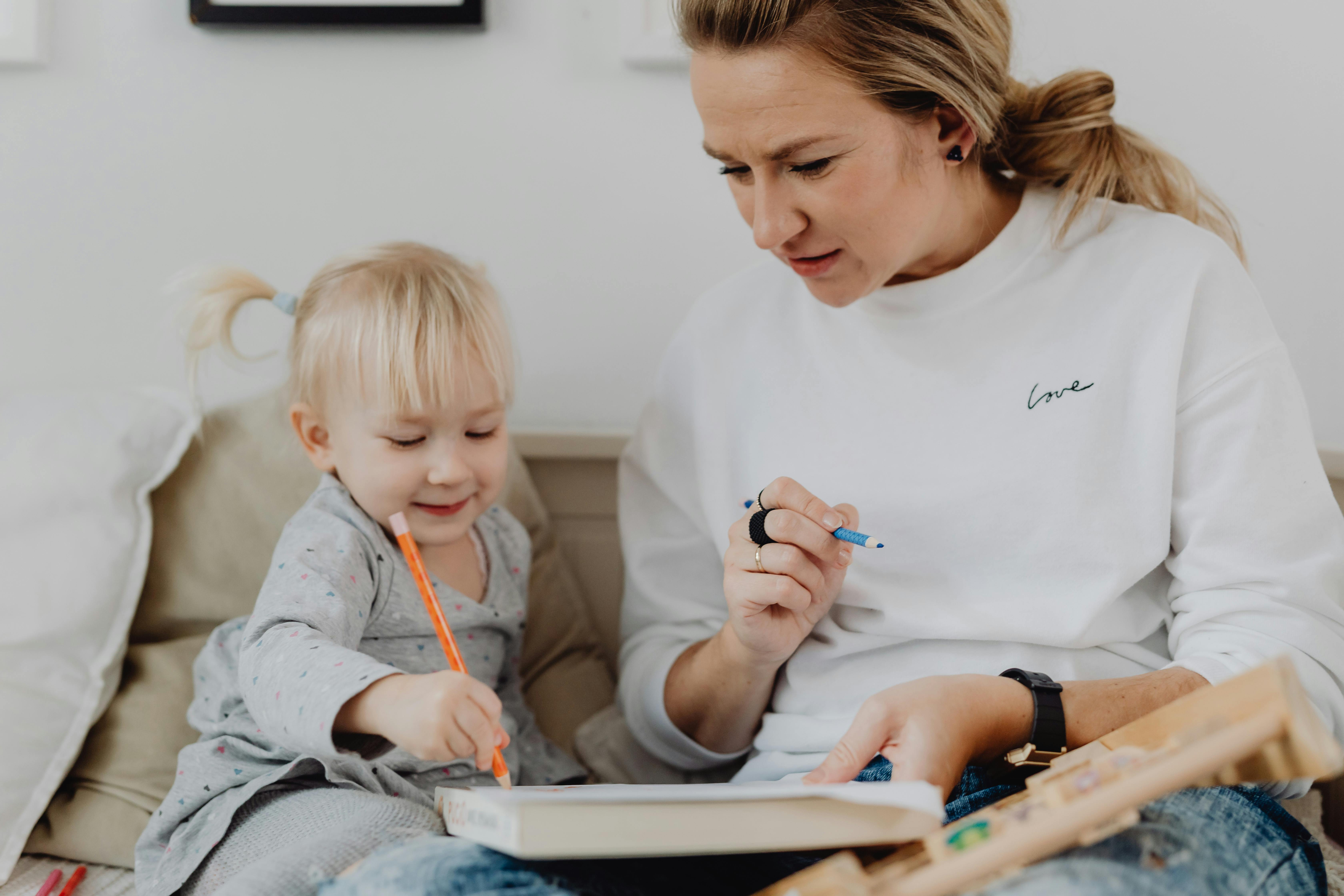 mother and child holding colored pencils