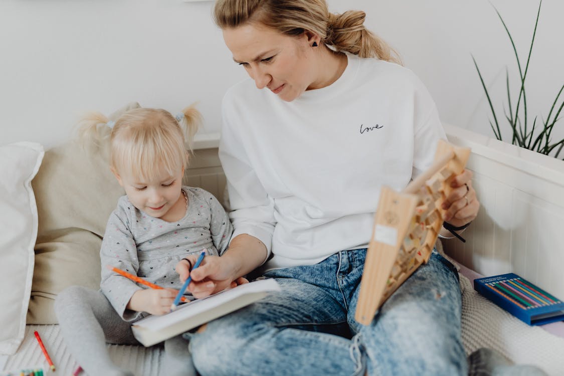 why do we have vacation homework Free A Mother Teaching her Daughter Stock Photo