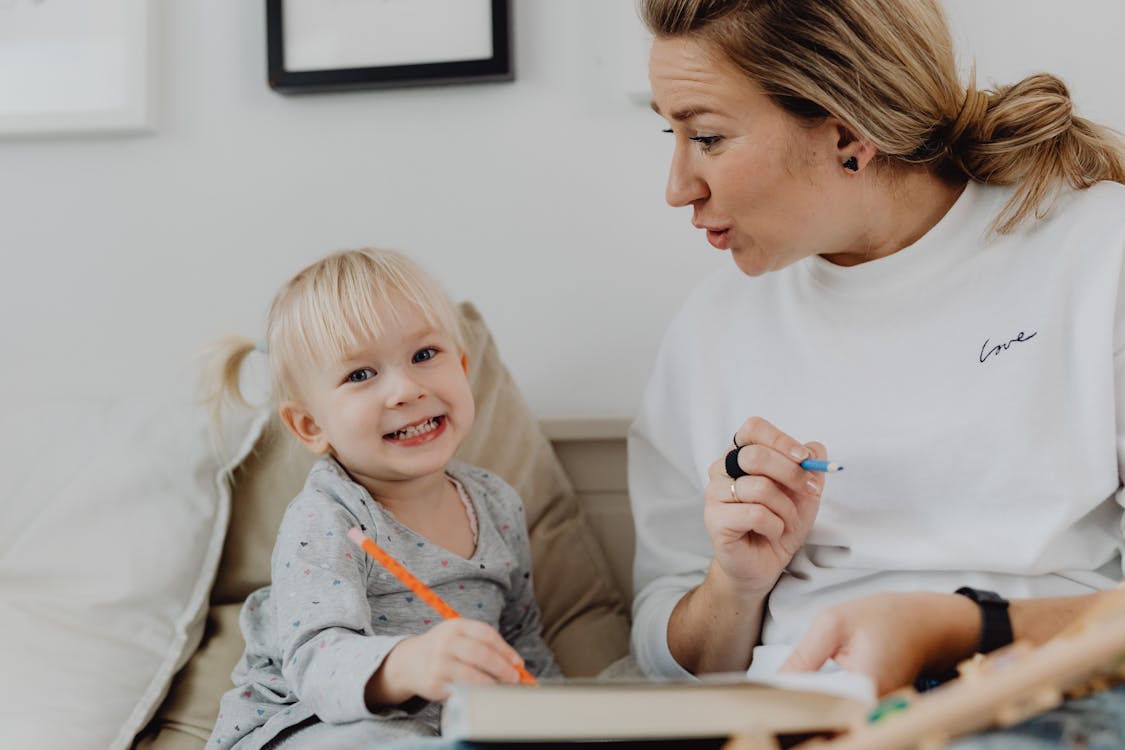 A Woman Teaching a Girl to Write