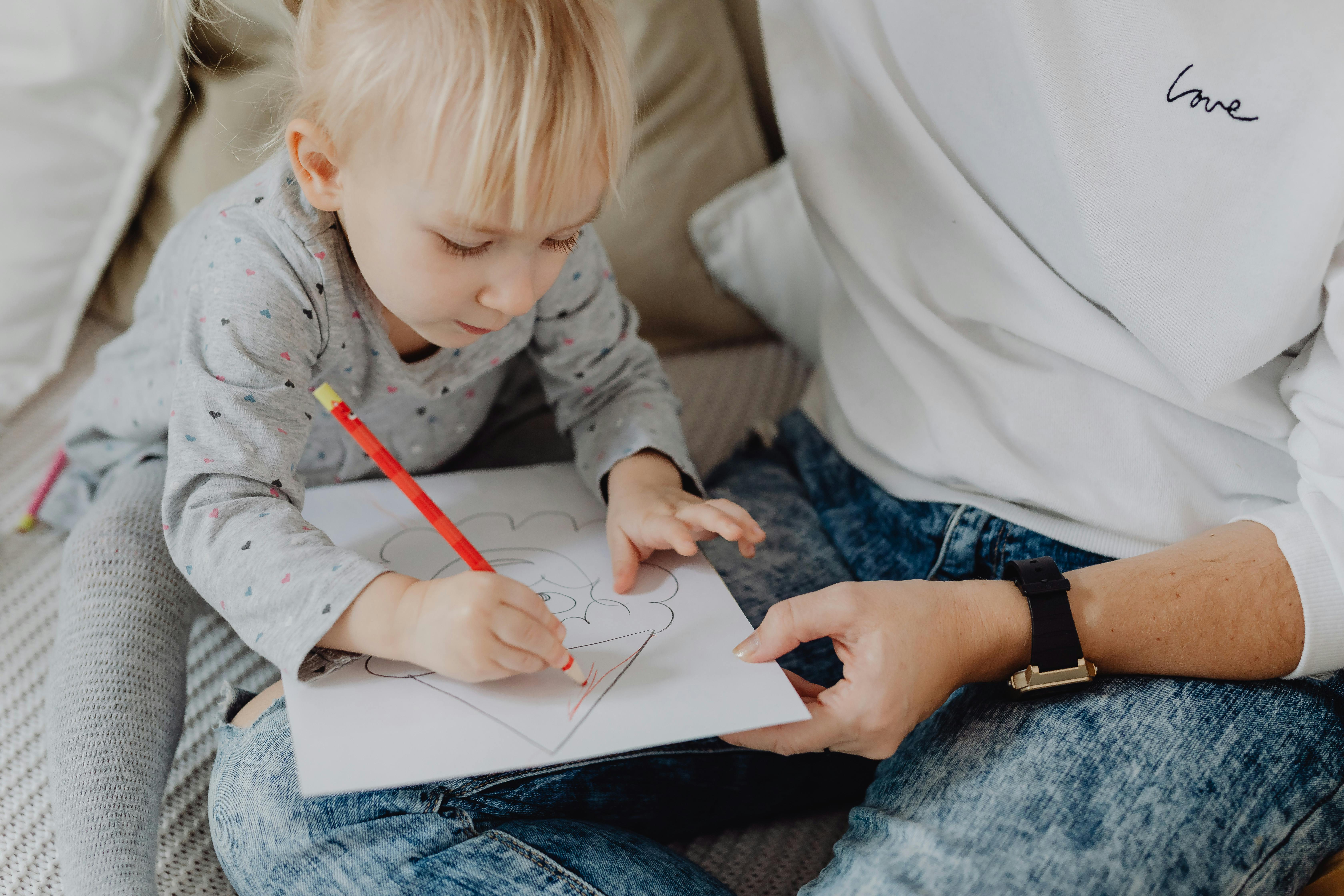 A Child Writing on a Piece of Paper