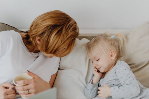 Free Mother and child bonding on a cozy bed, sharing a comforting and relaxing moment. Stock Photo