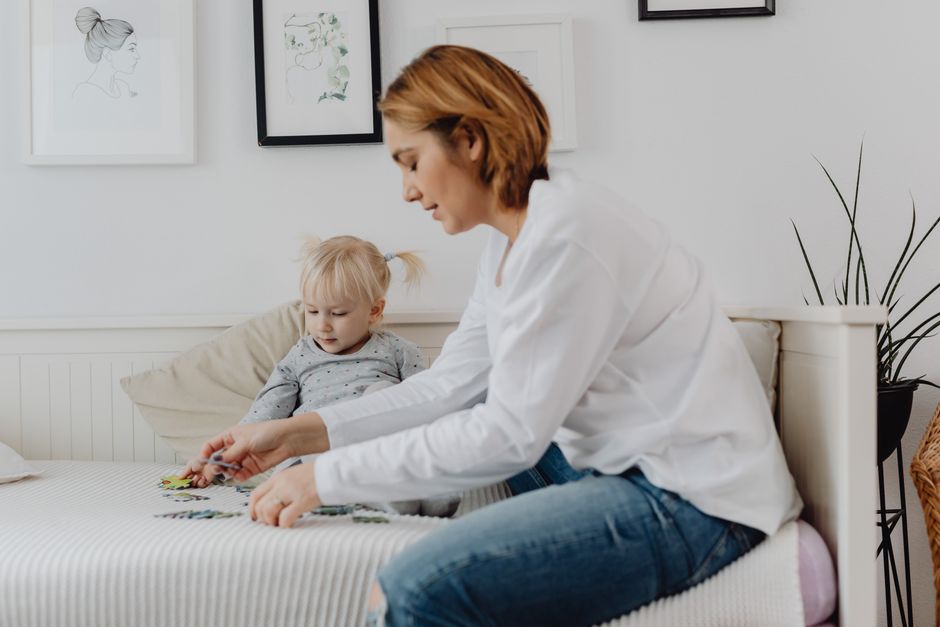 Photo by https://kaboompics.com/ on Pexels A mother and child enjoy a bonding moment solving puzzles on a bed in a cozy, light-filled bedroom. - Photo by https://kaboompics.com/ on Pexels