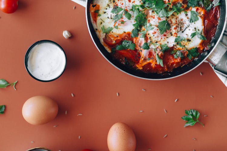 Fresh Eggs Near Cooked Food In A Pan