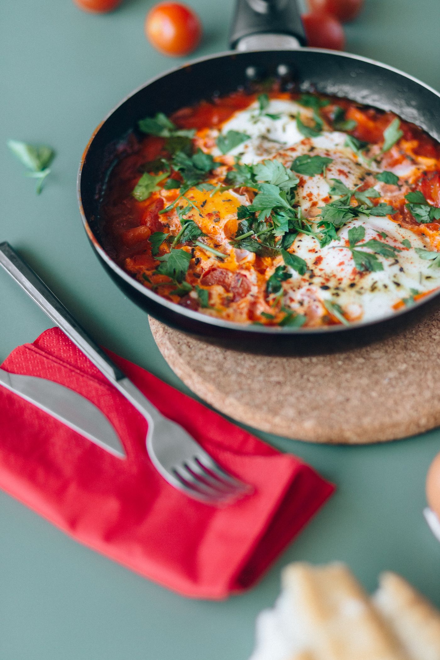 Shakshuka with eggs in tomato pepper sauce in a skillet