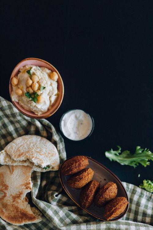 Free Top view of a falafel and hummus platter with pita bread, ideal for Mediterranean cuisine enthusiasts. Stock Photo