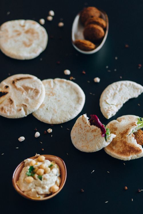 Free Fresh pita bread with falafel and creamy hummus, perfect for a traditional Middle Eastern meal. Stock Photo
