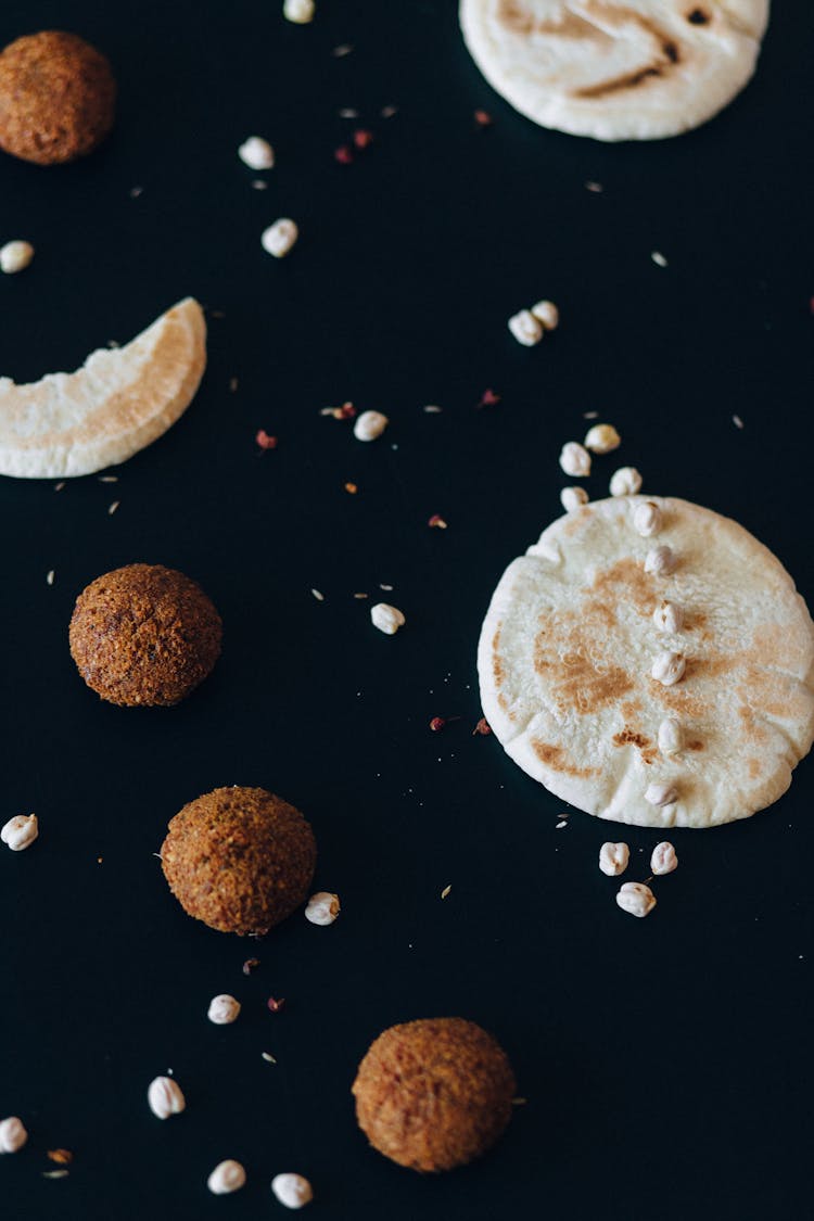 Falafel And Pita Breads On Black Surface