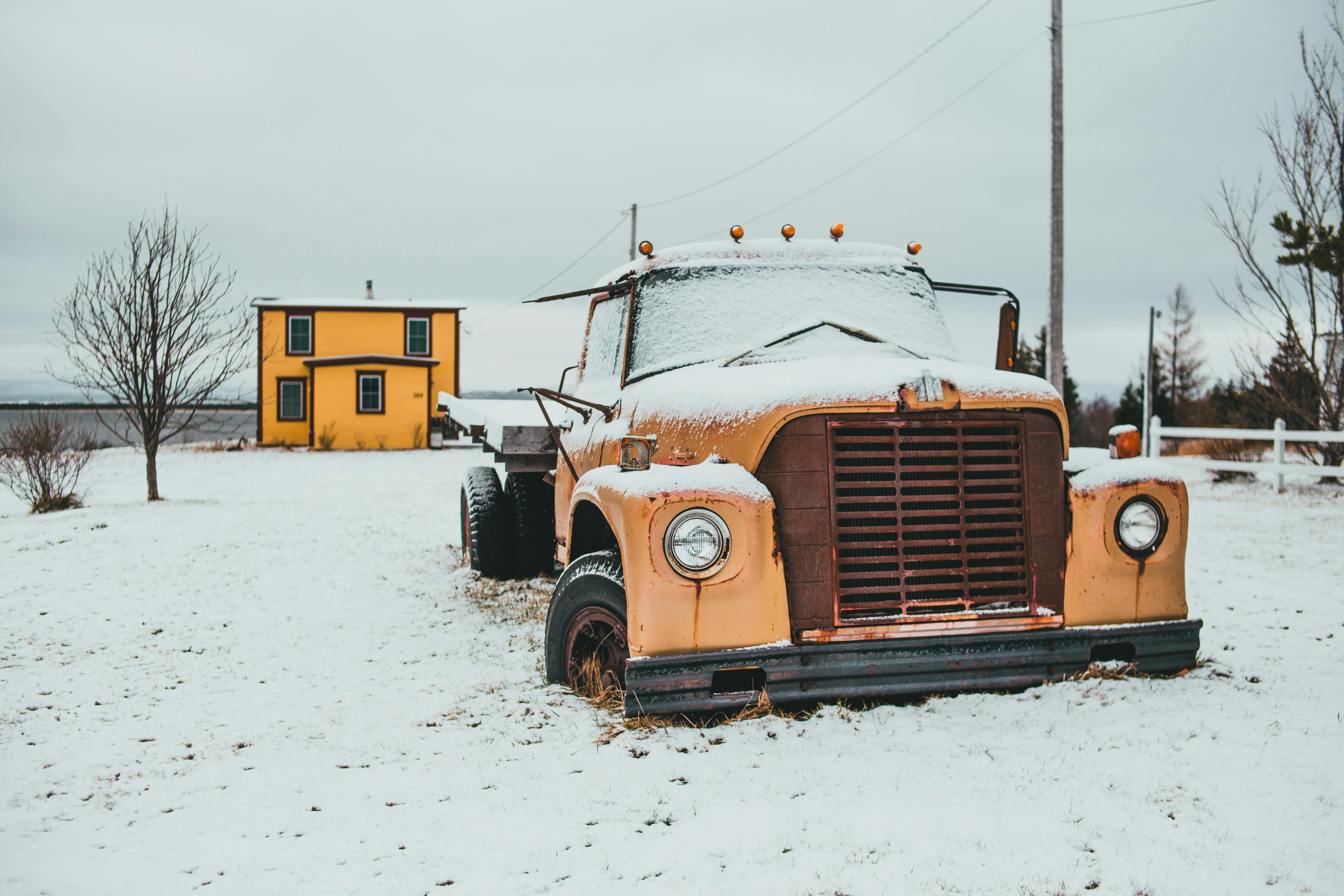 truck on snowy ground near building