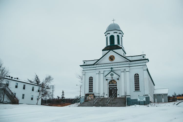 Exterior Of Catholic Church On Snowy Ground